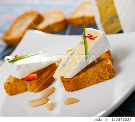 Canapes with soft blue cheese and orange Canapes with soft blue cheese and orange 125848527