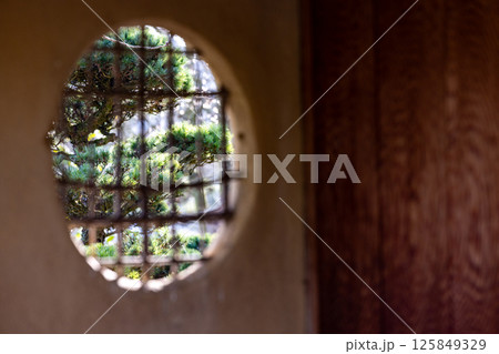 The Serene View Through a Beautiful Circular Window with an Elegant Lattice Design The Serene View Through a Beautiful Circular Window with an Elegant Lattice Design 125849329