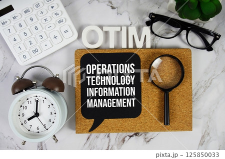 OTIM Operations, Technology, and Information Management acronym with calculator, alarm clock and magnifying glass, Business concept background 125850033