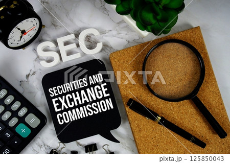 SEC - Securities And Exchange Commission acronym with calculator, alarm clock and magnifying glass, business concept background SEC - Securities And Exchange Commission acronym with calculator, alarm clock and magnifying glass, business concept background 125850043
