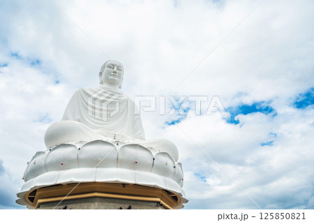 Vietnamese Large Buddhist Buddha statue at Long Son Pagoda in Nha Trang in Vietnam in Asia on background of sky 125850821