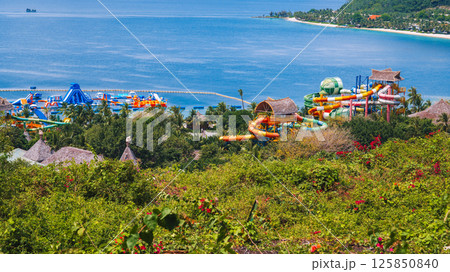big water park with slides and a swimming pool at resort in summer. Amusement park with aquapark by the sea big water park with slides and a swimming pool at resort in summer. Amusement park with aquapark by the sea 125850840