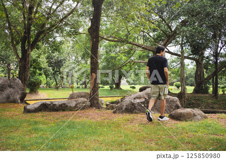 wellness concept with asian man exercise with tree in park on summer season wellness concept with asian man exercise with tree in park on summer season 125850980