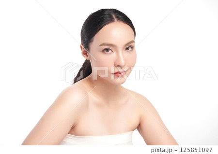 A beautiful young Asian woman with clean, fresh skin against a white background. Skincare, facial treatment, cosmetology, beauty, and spa. An elegant portrait of an Asian woman. 125851097