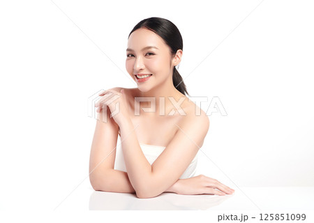 A beautiful young Asian woman with clean, fresh skin against a white background. Skincare, facial treatment, cosmetology, beauty, and spa. An elegant portrait of an Asian woman. 125851099