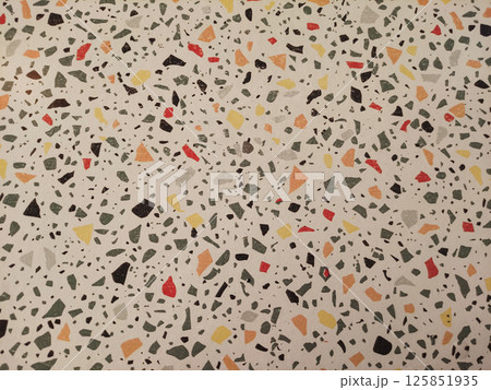 Textured surface of colorful terrazzo flooring showcasing a mosaic of various stone fragments and hues 125851935
