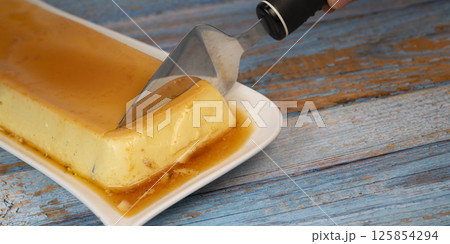 Cream caramel pudding with caramel sauce on a plate, Flan 125854294