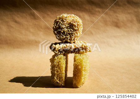 Creative food composition of ramen noodles over beige. Creative food composition of ramen noodles over beige. 125854402