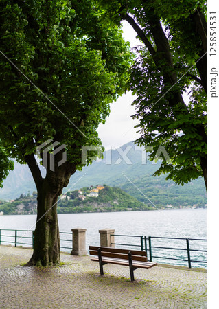 Scenic Lakeside Promenade with Benches and Mountain View Scenic Lakeside Promenade with Benches and Mountain View 125854531