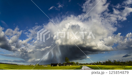 Anvil Cloud In The Sunny Day At with a rain. Anvil dome clouds are found in thunderstorm clouds usually in cumulonimbus clouds. 125854879