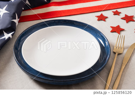 Table setting for USA Independence Day. Festive dinner with empty plate and decoration in USA national flag colors. Happy Patriotic Day. Close up. Copy space. Table setting for USA Independence Day. Festive dinner with empty plate and decoration in USA national flag colors. Happy Patriotic Day. Close up. Copy space. 125856120