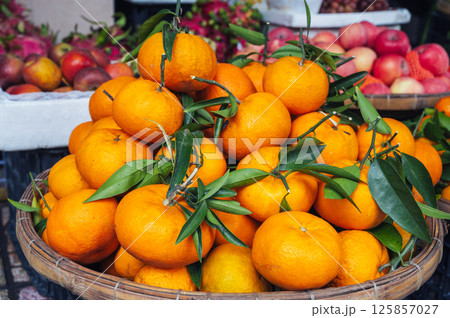 pile of fresh ripe sweet tangerines on the counter at market in Asia close-up 125857027