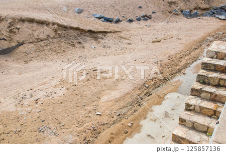 Sand, stones and ladder on the building or pit in Spain. Nature texture and grit in summer sun day. 125857136