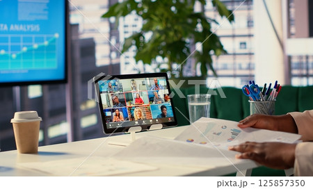Skilled ambitious female CEO negotiating with shareholders on online conference, asking for funds to sustain an expansion project. Businesswoman director driven for success, leadership. Camera A. 125857350