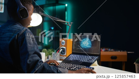 Data scientist using laptop, updating artificial intelligence machine learning algorithms, writing code scripts. Teleworking IT specialist in apartment office uses programming to upgrade AI, camera B Data scientist using laptop, updating artificial intelligence machine learning algorithms, writing code scripts. Teleworking IT specialist in apartment office uses programming to upgrade AI, camera B 125857463