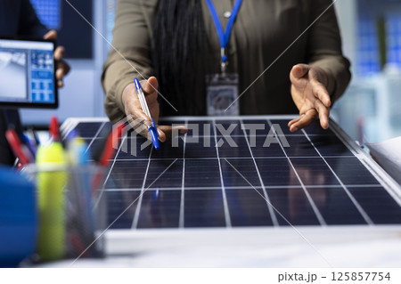 Scientists conduct research and development on solar panel efficiency, analyzing photovoltaic materials in high tech factory to enhance renewable energy production, close up shot Scientists conduct research and development on solar panel efficiency, analyzing photovoltaic materials in high tech factory to enhance renewable energy production, close up shot 125857754