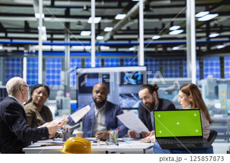 Factory company shareholders analyzing data, reviewing system health metrics with mockup laptop. Industrial plant investors in office troubleshooting issues using chroma key notebook 125857873