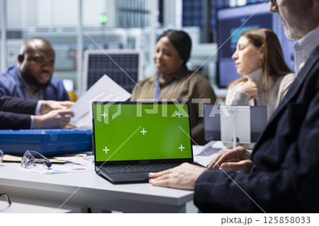 Shareholders and production plant manager analyzing sustainable manufacturing data using green screen laptop. Investors review documentation on chroma key notebook to evaluate investment profitability Shareholders and production plant manager analyzing sustainable manufacturing data using green screen laptop. Investors review documentation on chroma key notebook to evaluate investment profitability 125858033