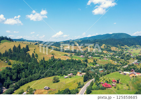 Aerial view of the mountains and village in the valley in spring. Beautiful nature landscape. Carpathian mountains. Ukraine Aerial view of the mountains and village in the valley in spring. Beautiful nature landscape. Carpathian mountains. Ukraine 125858685
