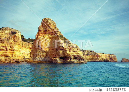 Coastal rocky seascape. Rocky shore near Praia da Marinha beach and Benagil in Algarve region in Atlantic ocean, Portugal, Europe 125858778