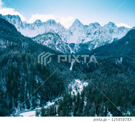 The tops of the mountains are covered with snow. View of the Alps in Gozd Martuljek, at sunrise. Triglav national park. Gozd Martuljek, Slovenia, Europe 125858783