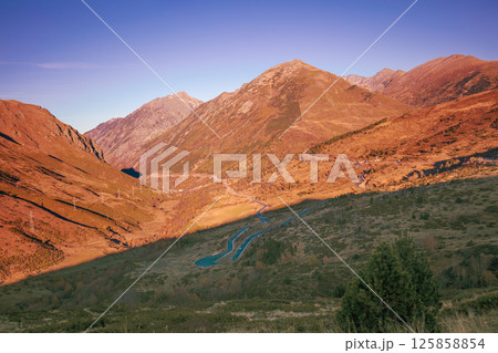 Mountain landscape with blue clear sky during sunset in autumn. Hiking The Pyrenees Mountains In Andorra 125858854