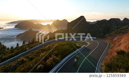 Motorcycle Rider Driving in High Mountain Landscape, Madeira Island , Portugal. Motorcycle Rider Driving in High Mountain Landscape, Madeira Island , Portugal. 125859369