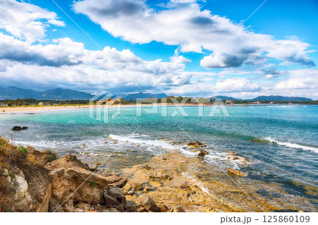 Astonishing view on  Nora bay and beach, the medieval Sant Efisio church near the shore. 125860109