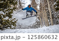 Snowboarding extreme sport. Man active sport lover snowboarder in motion over snowy mountains background. Tourism and travel. 125860632