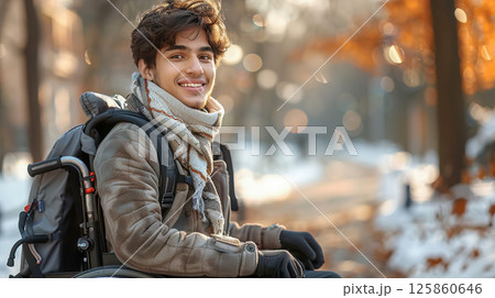 man in a wheelchair listening to music through headphones outdoors at sunset 125860646