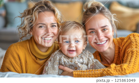 lesbian homosexual couple with their daughter baby at home. 125861049