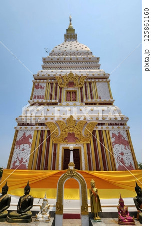 Magnificent Temple Structure with Golden Details and Statues Under Blue Sky 125861160