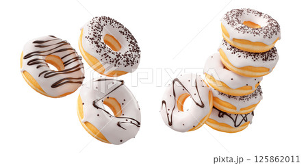 Donuts with white chocolate glaze, sprinkles, white drizzle, and dots isolated on white transparent background Donuts with white chocolate glaze, sprinkles, white drizzle, and dots isolated on white transparent background 125862011