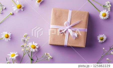 Gift box with daisy flower and ribbon purple copy space background 125862229
