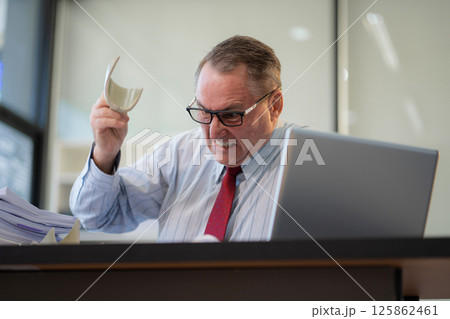 Stressed caucasian maturebusinessman working in the office. Stressed caucasian maturebusinessman working in the office. 125862461