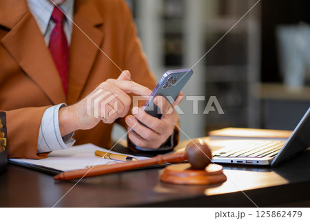 Male lawyer working at table at home office in the morning. Male lawyer working at table at home office in the morning. 125862479