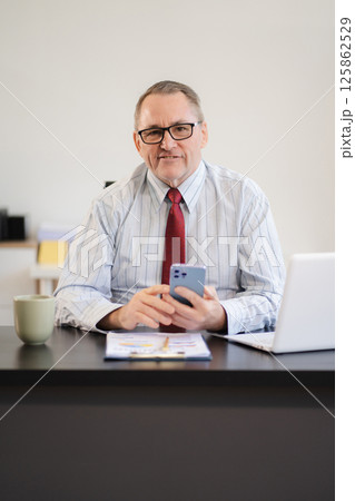 Businessman using laptop computer in office. success man, entrepreneur, small business owner working online. Businessman using laptop computer in office. success man, entrepreneur, small business owner working online. 125862529