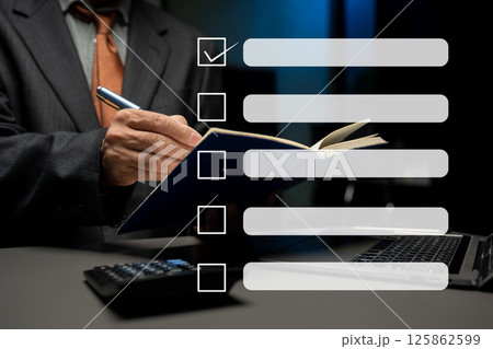 Business performance checklist concept, businessman using tablet and laptop doing online checklist survey, filling out digital form checklist. 125862599