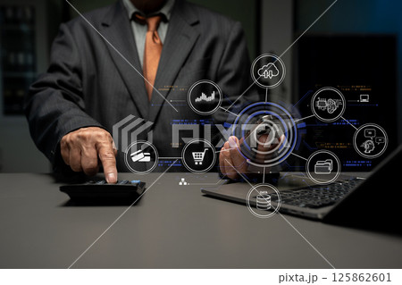 Businessman calculates financials with graph paper on the table on the cost of home office. Businessman calculates financials with graph paper on the table on the cost of home office. 125862601