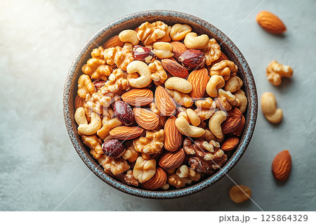 Healthy mix of almonds, walnuts and cashews in a bowl. Healthy mix of almonds, walnuts and cashews in a bowl. 125864329