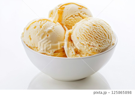 Creamy Vanilla Ice Cream Scoops in White Bowl with Caramel Drizzle Creamy Vanilla Ice Cream Scoops in White Bowl with Caramel Drizzle 125865898