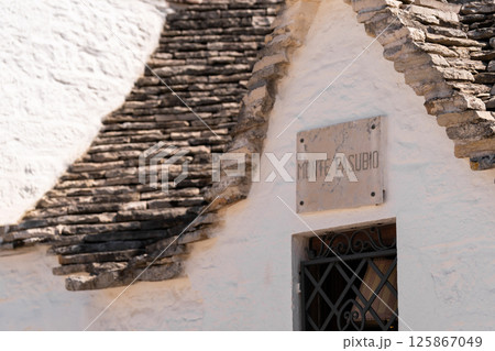 Stone Trulli house with "Monte Pasubio" sign Stone Trulli house with "Monte Pasubio" sign 125867049