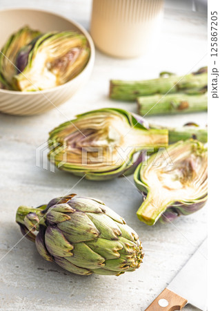 Ripe artichokes plant on kitchen table. Ripe artichokes plant on kitchen table. 125867205