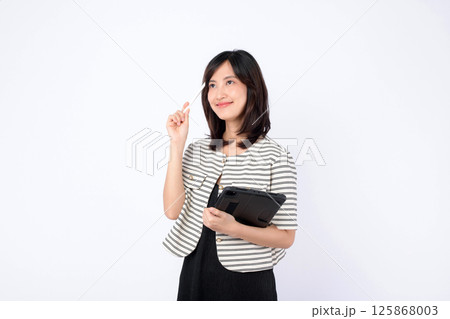 Southeast asian woman is small business owner in retail industry holding tablet and pen while thinking creatively about her online store startup with confidence and hope Southeast asian woman is small business owner in retail industry holding tablet and pen while thinking creatively about her online store startup with confidence and hope 125868003