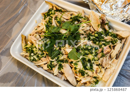 close up of homemade Chinese garlicky hand shredded chicken in a big tray with copy space close up of homemade Chinese garlicky hand shredded chicken in a big tray with copy space 125868487