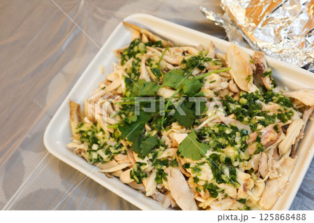 close up of homemade Chinese garlicky hand shredded chicken in a big tray with copy space 125868488