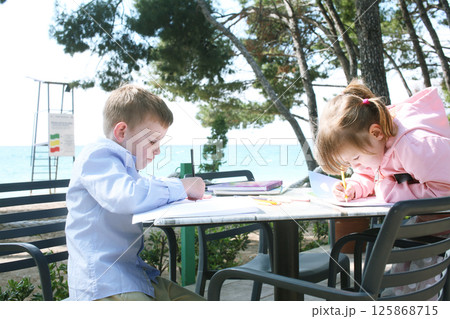 little cute boy and girl outside in cafe drawings, lifestyle family 125868715