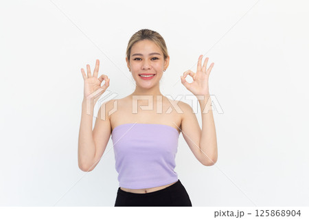 Portrait of Happy asian young woman smiling against made finger thumbs up OK gesture on white background 125868904