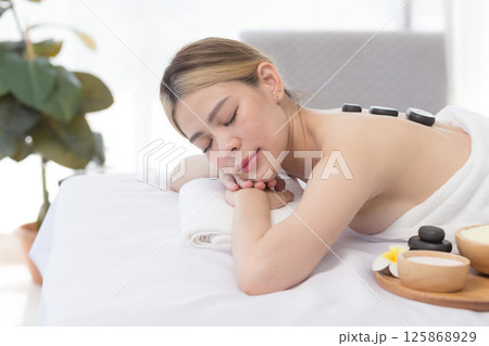 Young Asian Woman enjoying and relax massage in spa salon, Spa beauty massage healthy wellness , Lifestyle Healthy Concept. Young Asian Woman enjoying and relax massage in spa salon, Spa beauty massage healthy wellness , Lifestyle Healthy Concept. 125868929