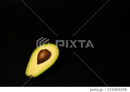 Avocado on a black background Avocado on a black background 125869299